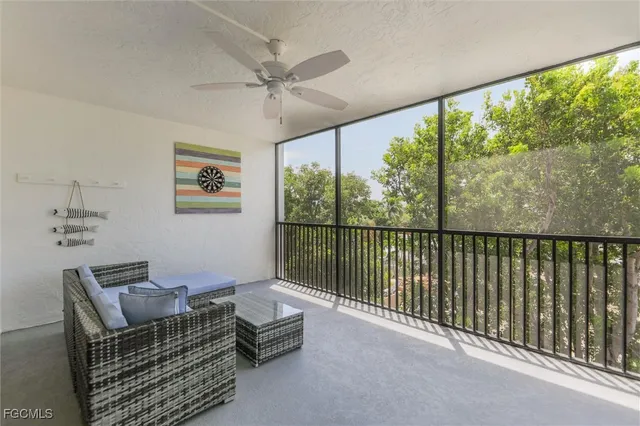 a living room with furniture and a floor to ceiling window