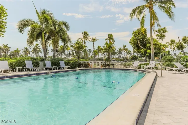 a view of a swimming pool with a lawn chairs