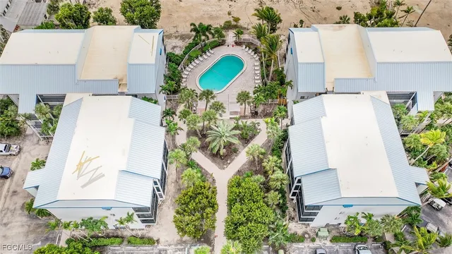 an aerial view of a house with a yard and a water fountain