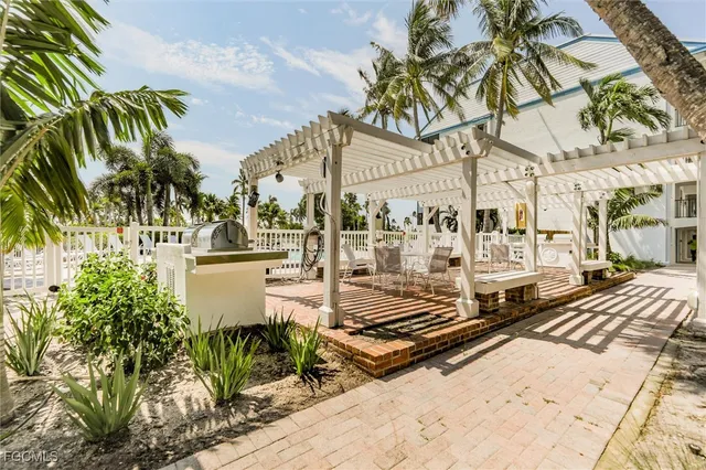 a view of a patio with a table and chairs and potted plants