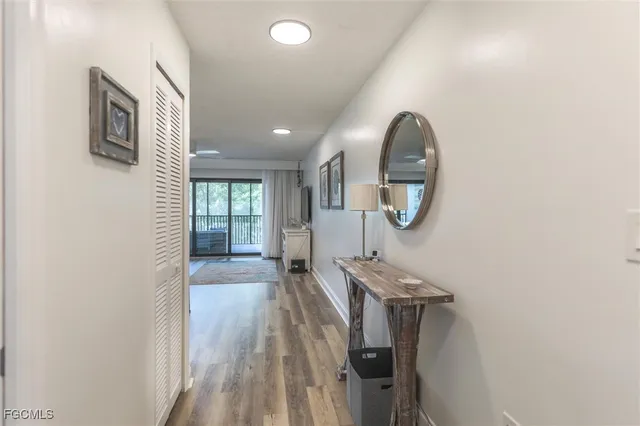 a view of a livingroom with wooden floor and a ceiling fan