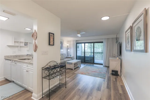 a view of a kitchen with furniture and wooden floor
