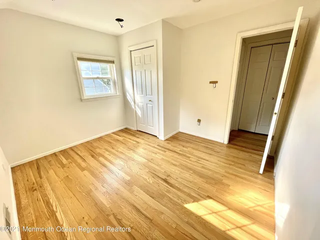 a view of a room with wooden floor and bathroom