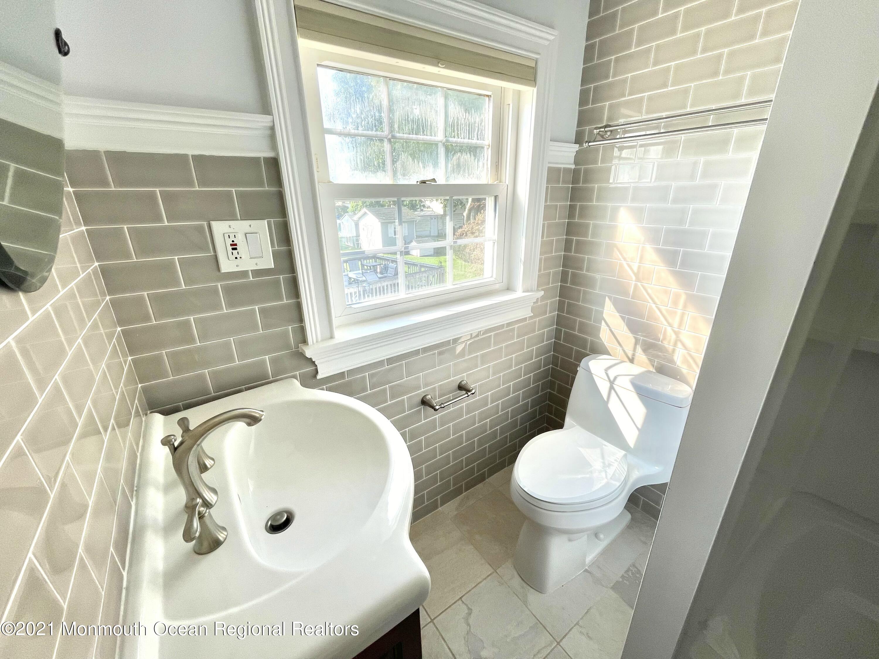 12 Branch Road Oakhurst, NJ 07755 - Photo 13 of 17 a bathroom with a sink toilet and shower