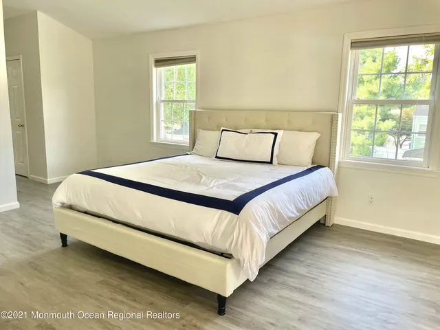 a spacious bedroom with a bed and a window