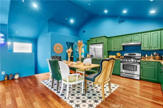 a kitchen with stainless steel appliances granite countertop a stove a sink and a refrigerator