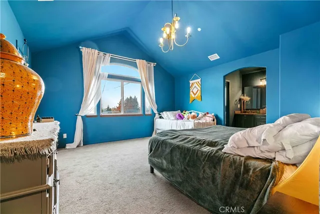 a bedroom with a bed window and dresser