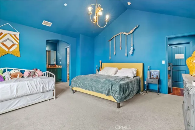 a bedroom with a bed and a dresser