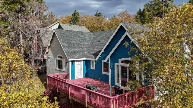 aerial view of a house with a chairs and table in a patio