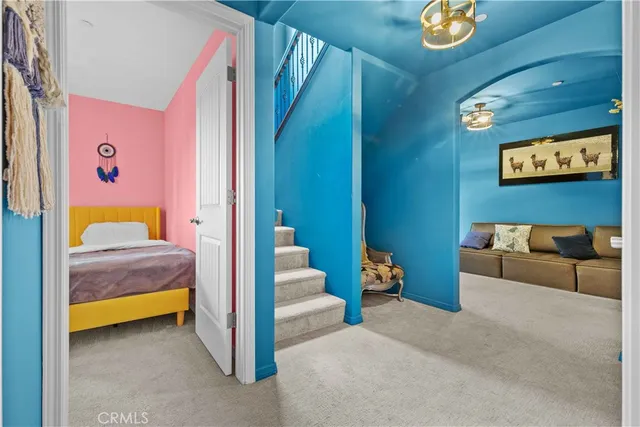 a spacious bedroom with a bed and a chandelier