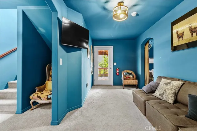 a living room with furniture chandelier and a window
