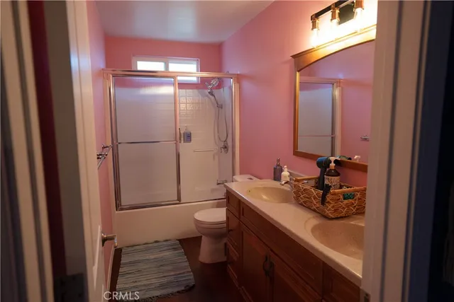 a en suite bathroom with a granite countertop sink and a mirror