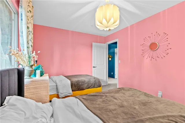 a bedroom with two beds and painted walls