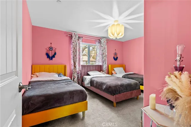 a bedroom with a bed a mirror and dresser