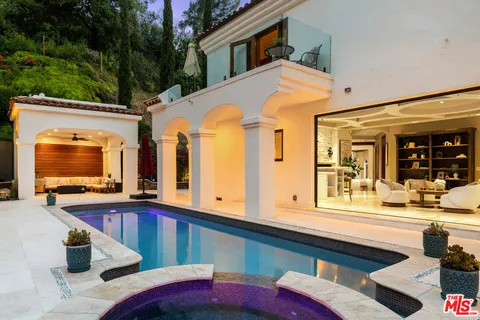 a view of a house with a balcony and car parked