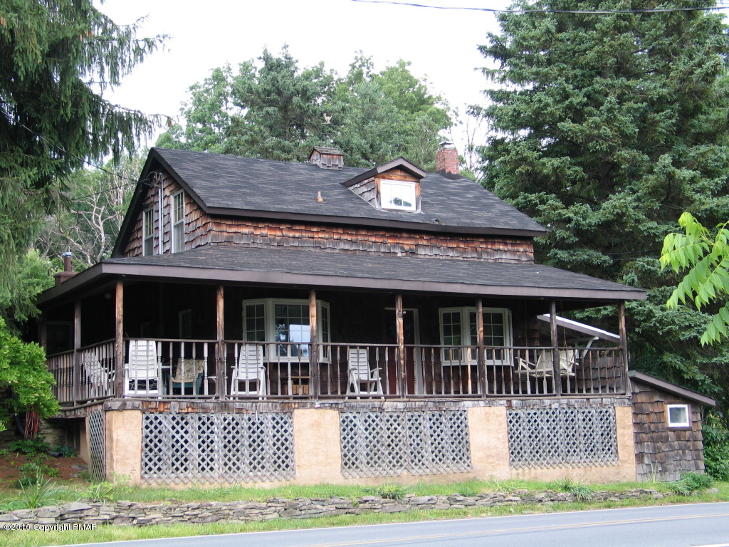 a view of house with a swimming pool