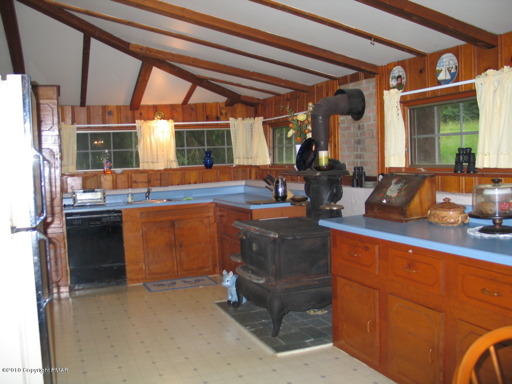 Summit Road Swiftwater, PA 18370 - Photo 2 of 12 a kitchen with granite countertop a sink and a refrigerator
