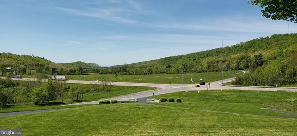 a view of a green field with clear sky