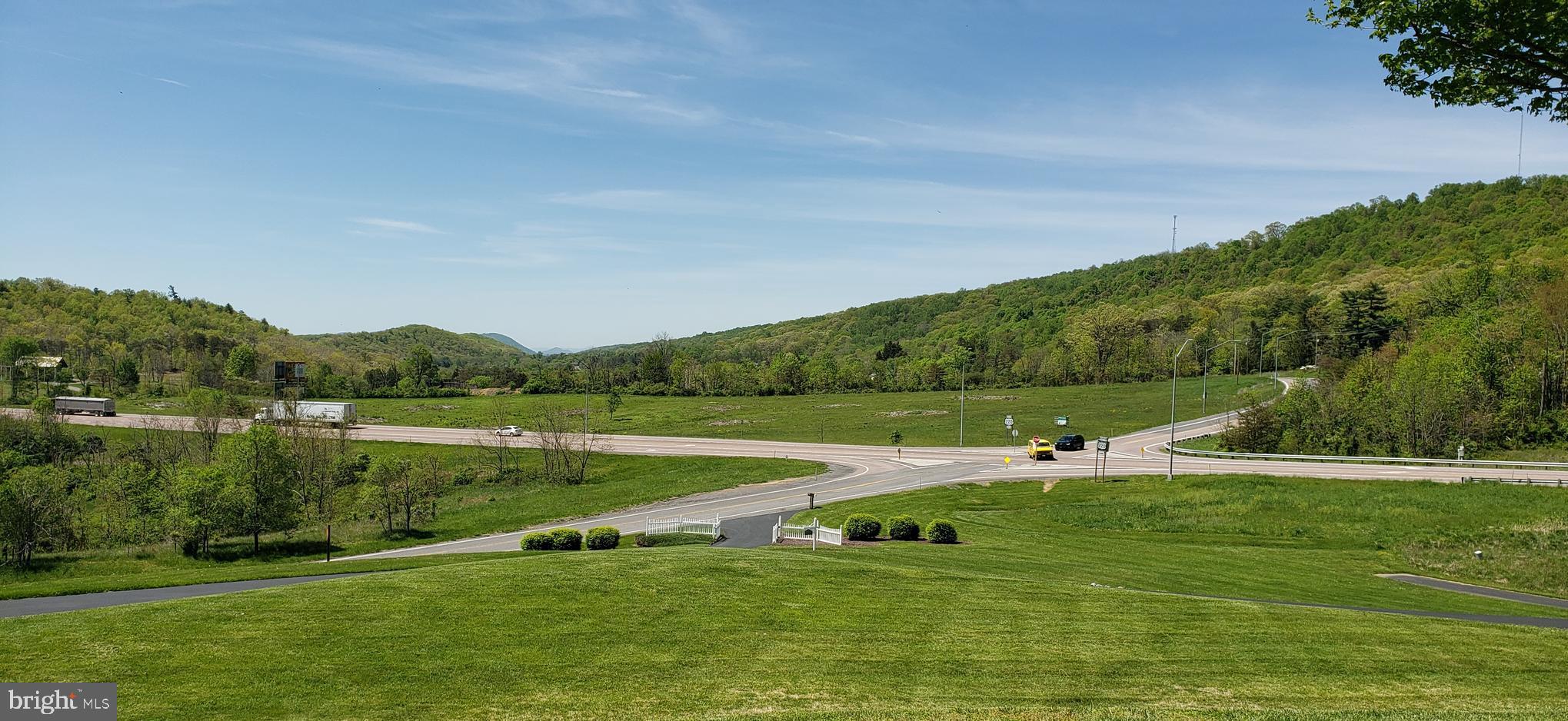 13910 Bedford Road Northeast Cumberland, MD 21502 - Photo 1 of 6 a view of a green field with clear sky