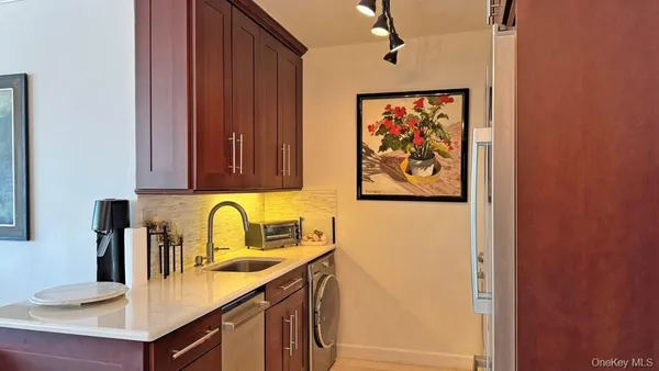 a kitchen with a sink and a refrigerator