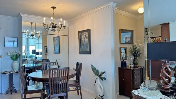 a view of a dining room with furniture and chandelier