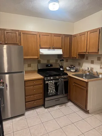 a kitchen with a refrigerator stove and cabinets