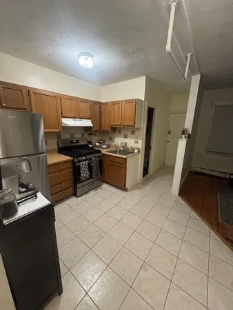 a kitchen with a sink and a stove top oven