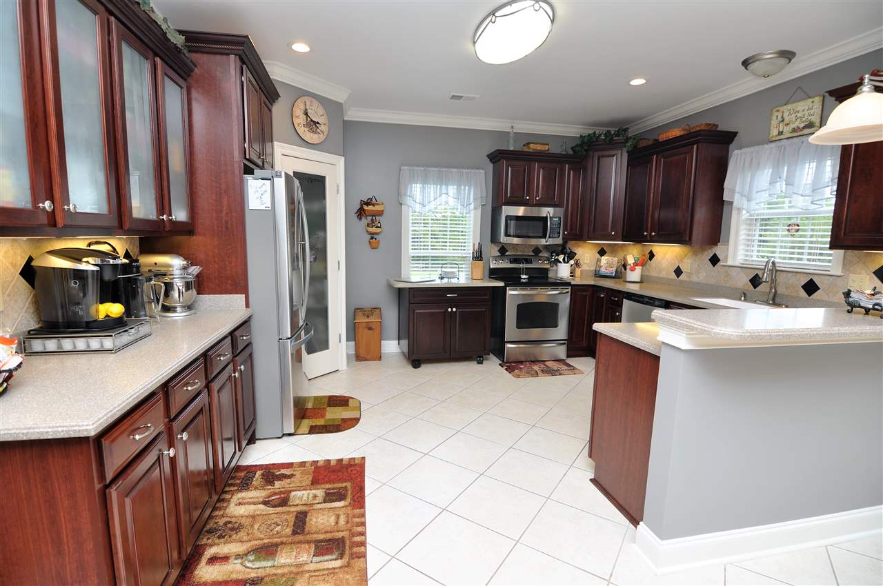 4420 Price Road Moscow, TN 38057 - Photo 13 of 25 The gourmet kitchen is accented with granite countertops, tile floor, recessed lighting, and tile backsplash.