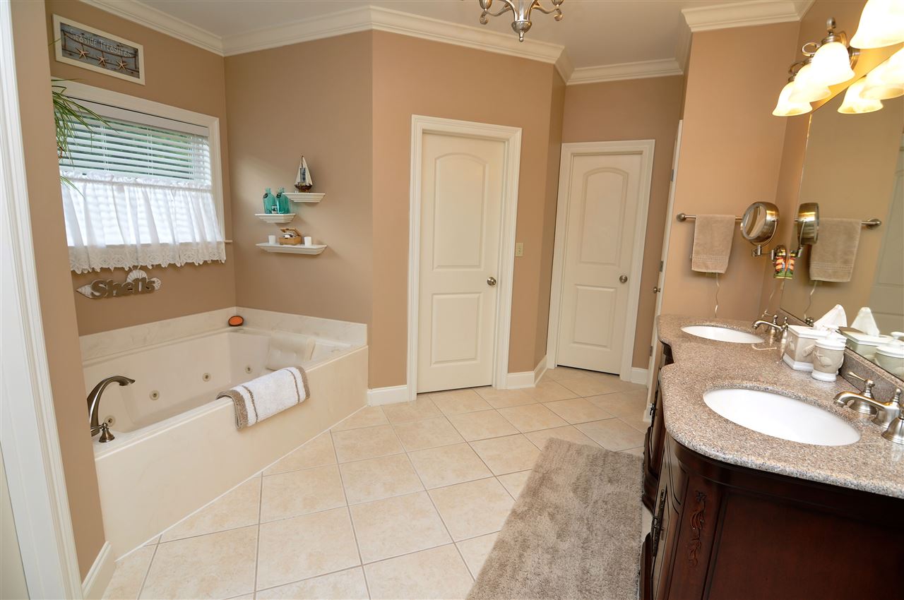 4420 Price Road Moscow, TN 38057 - Photo 17 of 25 The luxury bath enjoys a large walk-in closet, tile floor, and double vanities with granite tops.