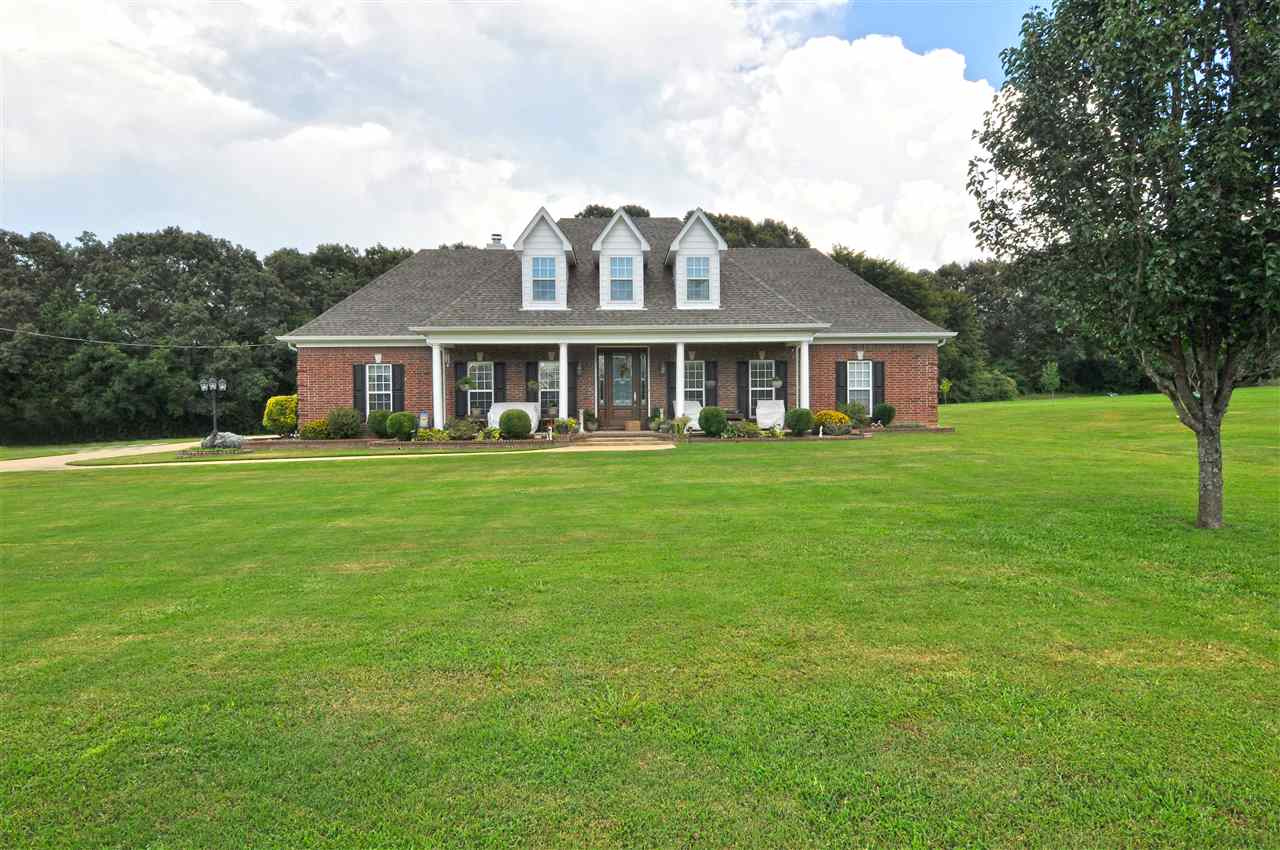 4420 Price Road Moscow, TN 38057 - Photo 4 of 25 Low maintenance brick exterior with large front porch surrounded by beautiful lush landscaping.