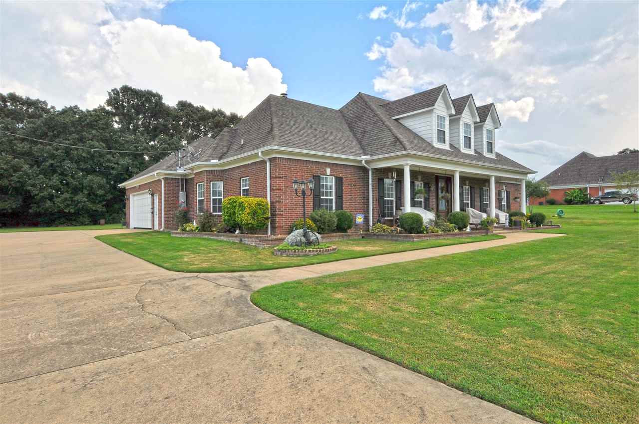 4420 Price Road Moscow, TN 38057 - Photo 6 of 25 A 2-car garage is located to the side of the home with additional parking for your guests and near the side entrance.