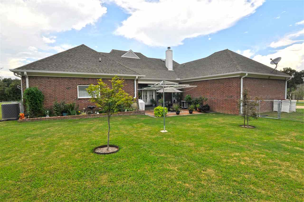 4420 Price Road Moscow, TN 38057 - Photo 8 of 25 The backyard is highlighted by beautiful lush landscaping with brick accents