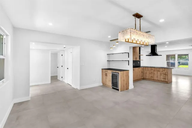 a view of a kitchen with a stove wooden floor kitchen and a window