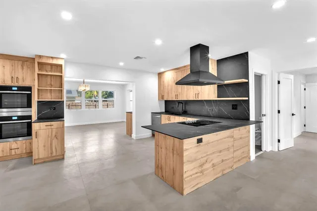 a kitchen with stainless steel appliances granite countertop a stove and a refrigerator