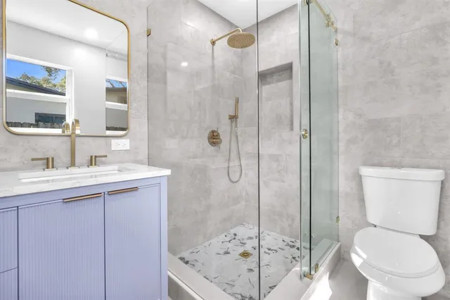 a bathroom with a sink toilet and shower