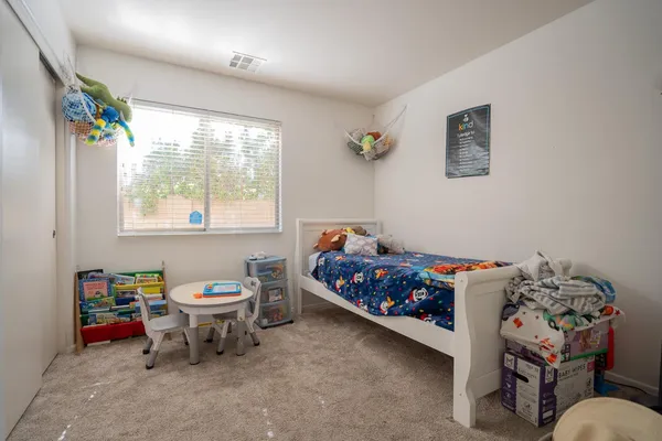 a bedroom with a bed and a window