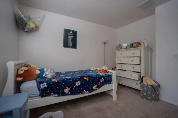 a bedroom with a bed and a couch