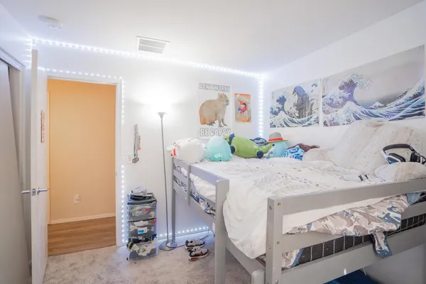 a bedroom with a bed and a table