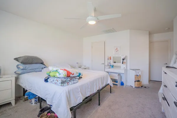 a bedroom with a bed and a table in it