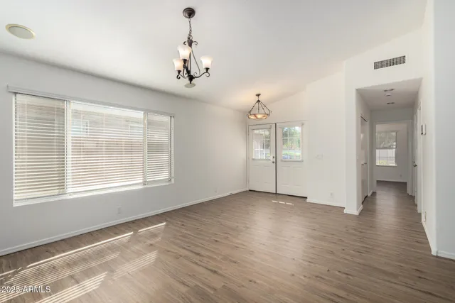 a living room with furniture a flat screen tv and a large window