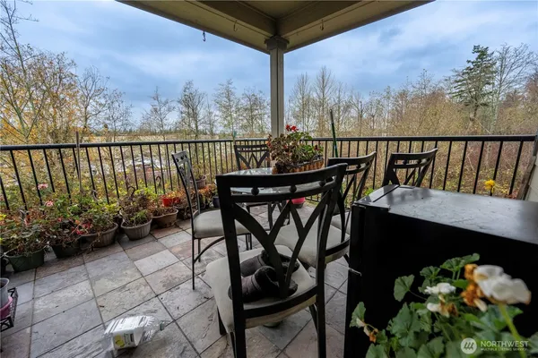 a view of a dining room with furniture and flowers