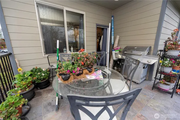 a view of a chairs and table in the balcony