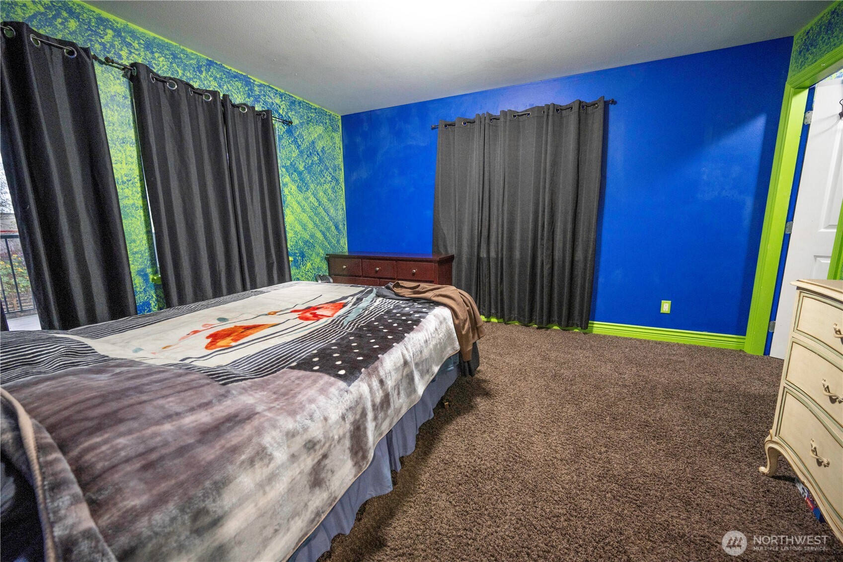 4173 Dover Street Bellingham, WA 98226 - Photo 34 of 40 a bed sitting in a bedroom next to a wooden door