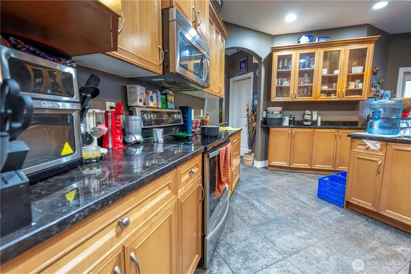 a kitchen with stainless steel appliances granite countertop a stove and cabinets