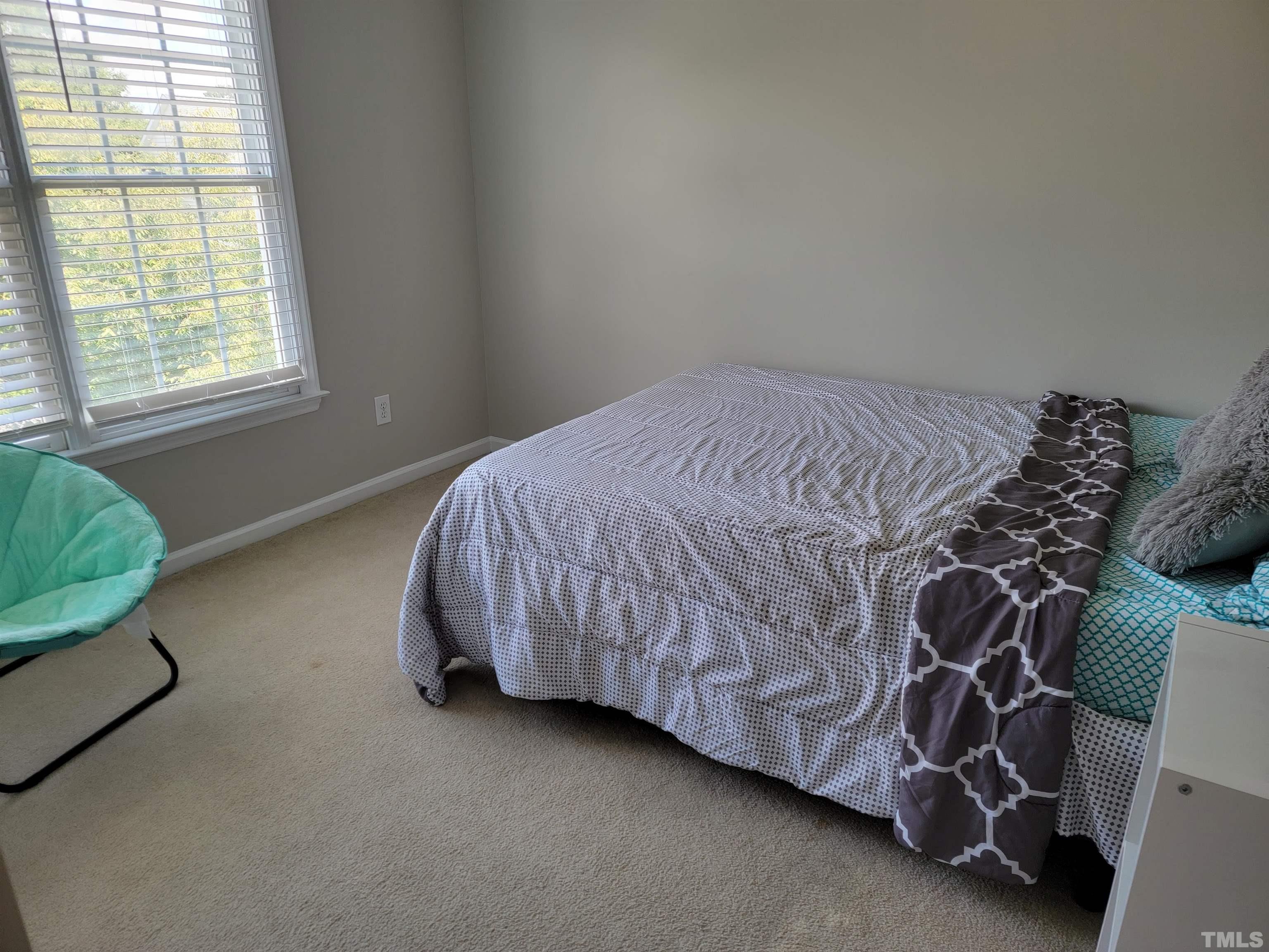 3301 Bellenden Place Raleigh, NC 27604 - Photo 16 of 30 a bed sitting in a bedroom next to a window