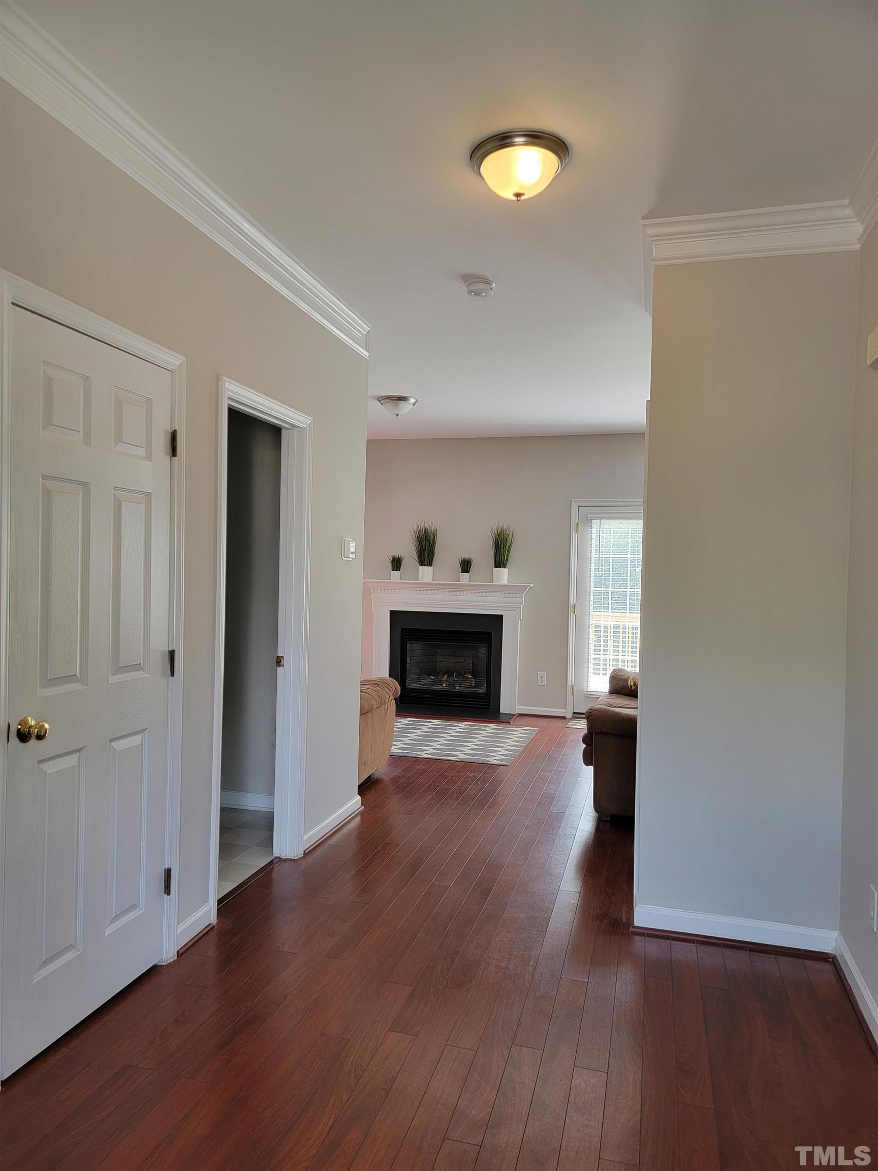 3301 Bellenden Place Raleigh, NC 27604 - Photo 3 of 30 an empty room with wooden floor fireplace and window
