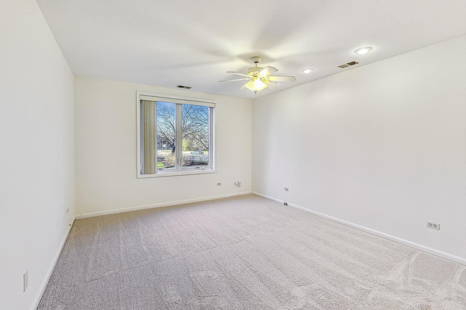 1175 Lake Cook Road, Unit 207 Northbrook, IL 60062 - Photo 19 of 28 wooden floor in an empty room with a window