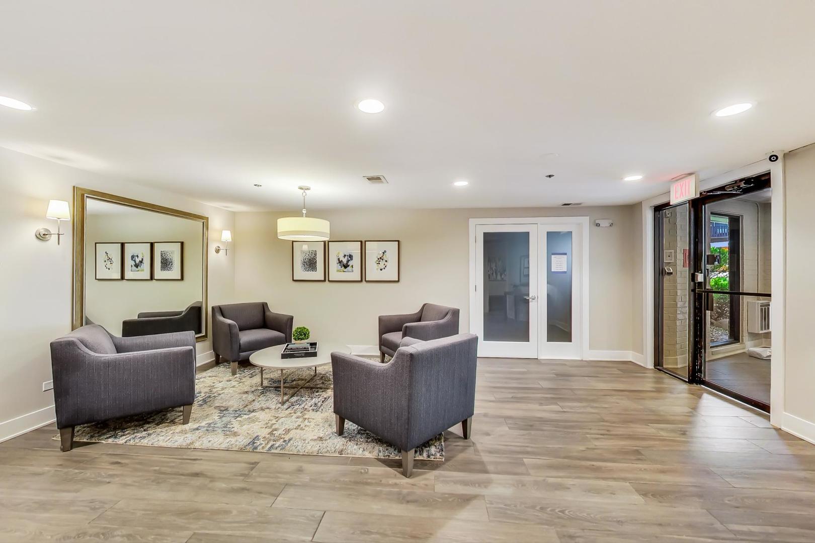 1175 Lake Cook Road, Unit 207 Northbrook, IL 60062 - Photo 2 of 28 a living room with furniture and a wooden floor