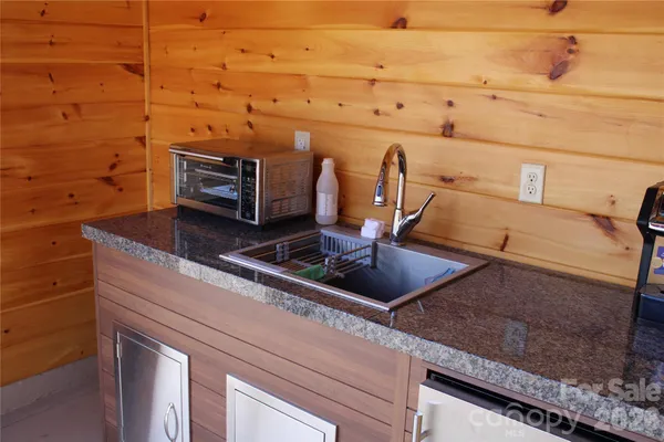 a front view of a house with a yard and garden