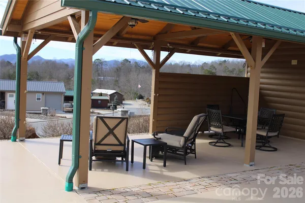 a view of a patio with table and chairs and potted plants